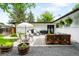 Backyard patio area with seating, plants, and a gravel landscape for outdoor entertaining at 7695 S Sheridan Ct, Littleton, CO 80128