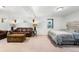 Finished basement with a comfortable seating area, a bed, and neutral color palettes at 7695 S Sheridan Ct, Littleton, CO 80128