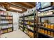 Organized basement storage shelves featuring ample canned goods, water, and supplies, perfect for any homeowner at 7695 S Sheridan Ct, Littleton, CO 80128
