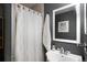 Cozy bathroom featuring a vanity, sink, mirror and shower with a white curtain at 7695 S Sheridan Ct, Littleton, CO 80128
