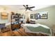 Cozy bedroom with wood floors, ceiling fan, and large windows with great natural light at 7695 S Sheridan Ct, Littleton, CO 80128
