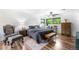 Comfortable bedroom with wood floors, a ceiling fan, and neutral decor, creating a relaxing atmosphere at 7695 S Sheridan Ct, Littleton, CO 80128