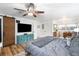 Spacious bedroom with wood floors, a ceiling fan, and ample natural light for a cozy retreat at 7695 S Sheridan Ct, Littleton, CO 80128