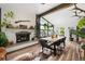 Beautiful dining room featuring a fireplace, hard wood floors, and a large window at 7695 S Sheridan Ct, Littleton, CO 80128