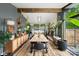 Beautiful dining room featuring a large wooden table, many plants and a view to the exterior at 7695 S Sheridan Ct, Littleton, CO 80128