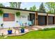 Inviting front exterior featuring a manicured lawn, vibrant decor, and a charming entrance, perfect for a warm welcome at 7695 S Sheridan Ct, Littleton, CO 80128