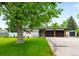 Charming ranch-style home featuring a well-manicured lawn and an attached two-car garage at 7695 S Sheridan Ct, Littleton, CO 80128