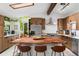 Modern kitchen with wooden cabinets, stainless steel appliances, and a butcher block island at 7695 S Sheridan Ct, Littleton, CO 80128