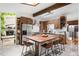 Bright kitchen featuring stainless steel appliances, wooden cabinets, and a butcher block island with seating at 7695 S Sheridan Ct, Littleton, CO 80128