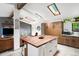 Modern kitchen with custom cabinets, white countertops and views to the living room at 7695 S Sheridan Ct, Littleton, CO 80128