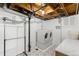Well-lit laundry room with a washer and dryer, utility sink, and tiled floors at 7695 S Sheridan Ct, Littleton, CO 80128