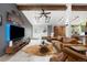 A bright living room with high ceilings, wooden beams, and tiled floors, creating an inviting space at 7695 S Sheridan Ct, Littleton, CO 80128