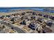 Aerial view of a neighborhood with a lake in the background and homes with solar panels at 6236 S Robertsdale Ct, Aurora, CO 80016