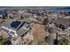 Aerial view of home with solar panels, patio with fire pit, and landscaped yard at 6236 S Robertsdale Ct, Aurora, CO 80016