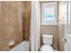 Bathroom featuring tiled shower and tub with a window providing natural light at 6236 S Robertsdale Ct, Aurora, CO 80016