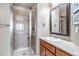 Bathroom featuring a glass shower and wooden vanity at 6236 S Robertsdale Ct, Aurora, CO 80016
