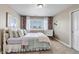 Cozy bedroom features a comfortable bed, stylish chair, and shuttered window at 6236 S Robertsdale Ct, Aurora, CO 80016