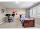 Well-lit bedroom features a single bed, desk area, and playful wall décor at 6236 S Robertsdale Ct, Aurora, CO 80016