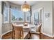 Cozy breakfast nook features large windows, a round table, and seating for four at 6236 S Robertsdale Ct, Aurora, CO 80016