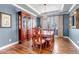 Elegant dining room with hardwood floors, a large china cabinet, and a stylish chandelier at 6236 S Robertsdale Ct, Aurora, CO 80016
