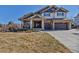 Inviting two-story home with a stone facade, covered porch, and a two-car garage at 6236 S Robertsdale Ct, Aurora, CO 80016
