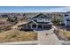 Lovely two-story home with a three-car garage, basketball hoop, and lake view at 6236 S Robertsdale Ct, Aurora, CO 80016