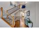 Elegant foyer with hardwood floors, iron-railed staircase, and stylish decor at 6236 S Robertsdale Ct, Aurora, CO 80016