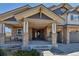 Inviting front porch with stone pillars and a seating area, creating a welcoming entrance at 6236 S Robertsdale Ct, Aurora, CO 80016