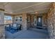 Cozy front porch with stone accents, comfortable seating, and a stylish front door at 6236 S Robertsdale Ct, Aurora, CO 80016