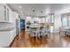 Spacious kitchen featuring white cabinets, a central island with bar seating, and stainless steel appliances at 6236 S Robertsdale Ct, Aurora, CO 80016