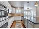 Bright kitchen features white cabinets, stainless steel appliances, and hardwood floors at 6236 S Robertsdale Ct, Aurora, CO 80016