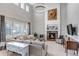 Bright living room with a fireplace, large windows, and comfortable seating at 6236 S Robertsdale Ct, Aurora, CO 80016