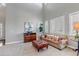 Sunlit living room with high ceilings, neutral tones, and comfortable seating arrangement at 6236 S Robertsdale Ct, Aurora, CO 80016