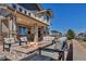 Beautiful stone patio with firepit, covered porch and ample seating at 6236 S Robertsdale Ct, Aurora, CO 80016