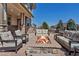 Outdoor patio with stone fire pit and comfortable seating at 6236 S Robertsdale Ct, Aurora, CO 80016