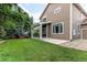 Spacious backyard featuring a well-maintained lawn, a covered patio, and lush landscaping at 13241 Heart Lake Way, Broomfield, CO 80020