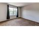 Bright bedroom with large window and dark drapes at 13241 Heart Lake Way, Broomfield, CO 80020