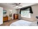 This bedroom features neutral paint, a ceiling fan, a window with curtains and a closet space visible through the doorway at 13241 Heart Lake Way, Broomfield, CO 80020