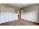 Bedroom featuring closet with sliding doors and view to a bathroom at 13241 Heart Lake Way, Broomfield, CO 80020