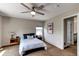 Cozy bedroom showcasing a comfortable bed, two wooden nightstands, natural light through the window, and neutral paint at 13241 Heart Lake Way, Broomfield, CO 80020