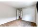 Bedroom featuring a closet with sliding doors and a doorway to a bathroom at 13241 Heart Lake Way, Broomfield, CO 80020