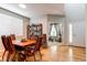 Bright dining room with wood floors, seating for six, and a view into the living area at 13241 Heart Lake Way, Broomfield, CO 80020