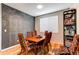 Stylish dining room with a decorative chalkboard wall, wood floors, and ample seating at 13241 Heart Lake Way, Broomfield, CO 80020