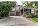 Inviting two-story home featuring a welcoming front porch and three-car garage at 13241 Heart Lake Way, Broomfield, CO 80020