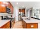 Well-equipped kitchen with stainless steel appliances, center island, and ample cabinet space at 13241 Heart Lake Way, Broomfield, CO 80020