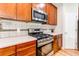 Updated kitchen with stainless steel appliances, a gas range, and ample counter space at 13241 Heart Lake Way, Broomfield, CO 80020