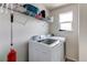 Laundry room featuring white, front-loading washer and dryer under a wire shelf at 13241 Heart Lake Way, Broomfield, CO 80020