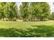 Community park with open green space, mature trees and picnic tables for residents to enjoy at 13241 Heart Lake Way, Broomfield, CO 80020