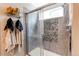 Modern shower with glass doors, and a small window for lighting at 13241 Heart Lake Way, Broomfield, CO 80020