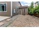 Functional side yard with a gravel bed and access to a small utility door at 13241 Heart Lake Way, Broomfield, CO 80020